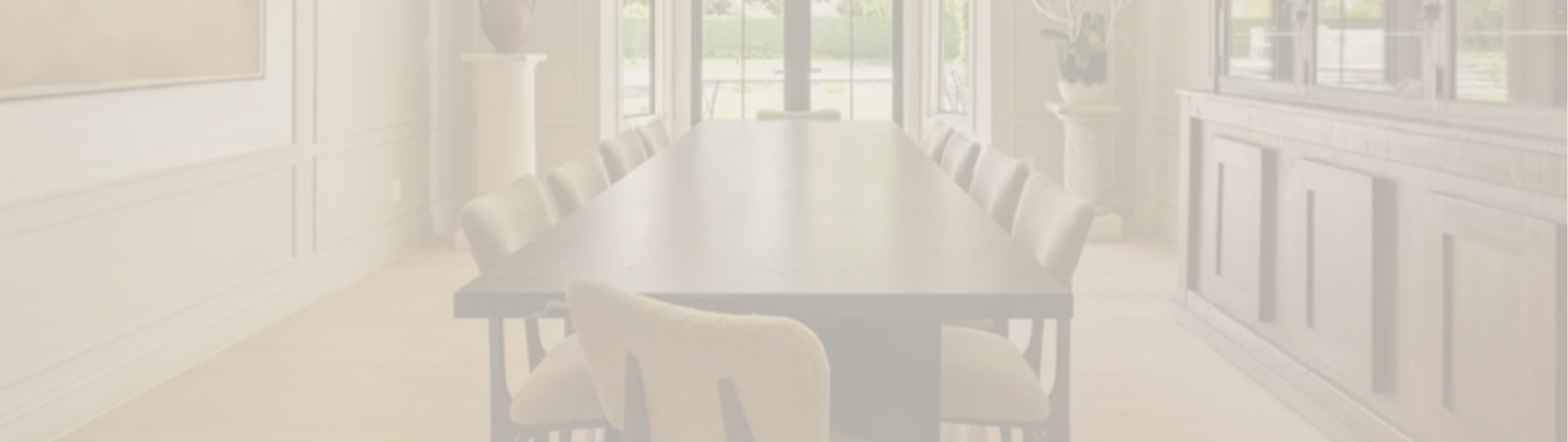 Dining room with a table and chairs in a softly lit room.